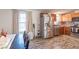 Bright kitchen with stainless steel appliances, wooden cabinets, and durable wood flooring at 10614 W Hickory Ct, Quincy, IN 47456
