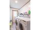 Well-equipped laundry room with a modern washer and dryer, along with a storage shelf at 10614 W Hickory Ct, Quincy, IN 47456