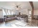 Comfortable living room with wood flooring, a sectional sofa, and lots of natural light at 10614 W Hickory Ct, Quincy, IN 47456
