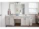 Bright bathroom featuring a double vanity with granite countertop and ample storage space at 10799 Belair Dr, Carmel, IN 46280