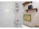 Clean bathroom featuring a white subway tile shower, wooden shelves, and modern fixtures at 10799 Belair Dr, Carmel, IN 46280