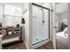 Modern bathroom with a sleek glass-enclosed shower, wooden shelving, and stylish decor at 10799 Belair Dr, Carmel, IN 46280