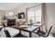 Open-concept dining room seamlessly connects to a cozy living room with fireplace and TV at 10799 Belair Dr, Carmel, IN 46280