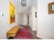 Stylish hallway with a vibrant rug, a comfortable bench, and eye-catching art at 10799 Belair Dr, Carmel, IN 46280