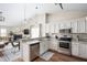 Open-concept kitchen with stainless steel appliances, granite countertops, and seamless flow to the living area at 10799 Belair Dr, Carmel, IN 46280
