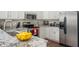 Upgraded kitchen with stainless steel appliances, white cabinets, and beautiful granite countertops at 10799 Belair Dr, Carmel, IN 46280