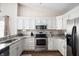 Bright kitchen boasts granite countertops, stainless steel appliances, and ample cabinet space at 10799 Belair Dr, Carmel, IN 46280