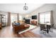 Inviting living room with a modern fireplace, hardwood floors, and a contemporary lighting fixture at 10799 Belair Dr, Carmel, IN 46280