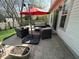 Outdoor patio with comfortable seating under a large umbrella, perfect for relaxing or entertaining guests at 10799 Belair Dr, Carmel, IN 46280