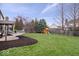 Backyard featuring a play set, mulch and a well maintained lawn at 10889 Weston Dr, Carmel, IN 46032