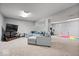 Spacious finished basement with a gray sectional couch and workout equipment at 10889 Weston Dr, Carmel, IN 46032