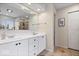 Bathroom featuring double sinks, white cabinets, and tiled floors at 10889 Weston Dr, Carmel, IN 46032