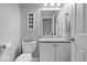 Cozy bathroom featuring a granite countertop, framed pictures, and a white vanity at 10889 Weston Dr, Carmel, IN 46032