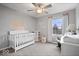 Bright bedroom featuring a crib, soft colors, and natural light at 10889 Weston Dr, Carmel, IN 46032