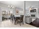 View of dining area featuring a dining table with seating, a sliding glass door, and sightlines into living room at 10889 Weston Dr, Carmel, IN 46032