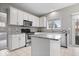 Bright kitchen with stainless steel appliances, white cabinets, granite countertops, and a convenient kitchen island at 10889 Weston Dr, Carmel, IN 46032