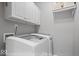 Clean and modern laundry room with white cabinets, and new washer and dryer, offering convenience and functionality at 10889 Weston Dr, Carmel, IN 46032
