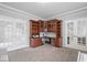 Office space featuring French doors, custom wooden cabinets, neutral paint colors, and plush carpeting at 10889 Weston Dr, Carmel, IN 46032