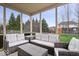 Screened-in patio with wicker seating, perfect for outdoor relaxation at 10889 Weston Dr, Carmel, IN 46032