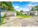 Expansive backyard showcasing multiple structures, including garage, lush greenery, and a basketball hoop for active enjoyment at 11416 Stoeppelwerth Dr, Indianapolis, IN 46229