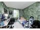 Comfortable bedroom with green accent wall, desk, window and colorful decor, creating a cozy and inviting space at 11416 Stoeppelwerth Dr, Indianapolis, IN 46229