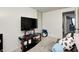 Functional bedroom features neutral walls, a cozy couch, and a TV on a stand, perfect for relaxation at 11416 Stoeppelwerth Dr, Indianapolis, IN 46229