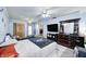 Spacious bedroom with blue walls, ceiling fans, and dresser, filled with natural light at 11416 Stoeppelwerth Dr, Indianapolis, IN 46229
