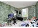 Comfortable bedroom with green accent wall, desk, window and colorful decor, creating a cozy and inviting space at 11416 Stoeppelwerth Dr, Indianapolis, IN 46229