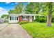 Charming single story home with red brick and white siding, green lawn and partial driveway at 11416 Stoeppelwerth Dr, Indianapolis, IN 46229