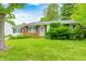 Charming single-story home featuring brick accents, blue shutters, and a well-manicured front yard at 11416 Stoeppelwerth Dr, Indianapolis, IN 46229
