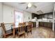 Kitchen and dining area featuring wood cabinets, ceiling fan, and tile floors at 11416 Stoeppelwerth Dr, Indianapolis, IN 46229
