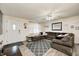 Spacious living room featuring a large sectional, ceiling fan, and neutral color palette at 11416 Stoeppelwerth Dr, Indianapolis, IN 46229