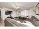 Comfortable living room with large sofa, ceiling fan, and door to front yard at 11416 Stoeppelwerth Dr, Indianapolis, IN 46229