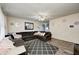 Cozy living room with a large sectional sofa, ceiling fan, and stylish decor at 11416 Stoeppelwerth Dr, Indianapolis, IN 46229