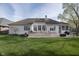 Well-kept backyard featuring a large deck, outdoor seating, and a lush lawn, perfect for relaxation and entertaining at 11930 Pebblepointe Pass, Carmel, IN 46033