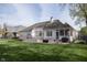 Expansive backyard with a well-manicured lawn, wooden deck and screened-in porch for outdoor enjoyment at 11930 Pebblepointe Pass, Carmel, IN 46033