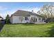 Spacious backyard with a lush green lawn, mature trees, and an inviting deck with comfortable seating at 11930 Pebblepointe Pass, Carmel, IN 46033