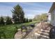 Outdoor living space with a dining set and grill next to a charming paver and wood patio at 11930 Pebblepointe Pass, Carmel, IN 46033
