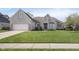 Charming, light brick home with an attached garage and meticulously maintained front yard at 11930 Pebblepointe Pass, Carmel, IN 46033