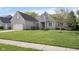 Charming single-story home with a large front lawn, a two-car garage and a welcoming entryway at 11930 Pebblepointe Pass, Carmel, IN 46033