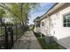 View of a side yard with a stone path and privacy fence, featuring manicured landscaping and charming details at 11930 Pebblepointe Pass, Carmel, IN 46033