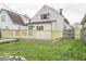 The house features a newly-built deck that surrounds the back of the home, overlooking a green yard at 126 S 3Rd Ave, Beech Grove, IN 46107