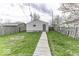 Backyard view with a wooden walkway leading to detached garage at 126 S 3Rd Ave, Beech Grove, IN 46107