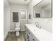 Bright bathroom with modern vanity, updated fixtures, and sleek wood-look flooring at 126 S 3Rd Ave, Beech Grove, IN 46107