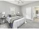 Charming bedroom featuring plush carpeting, a ceiling fan, and access to an ensuite bathroom at 126 S 3Rd Ave, Beech Grove, IN 46107