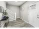 Bright entryway featuring hardwood floors, staircase and stylish decor, providing a welcoming ambiance at 126 S 3Rd Ave, Beech Grove, IN 46107