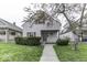 Charming two-story home featuring a covered front porch and well-maintained landscaping, creating curb appeal at 126 S 3Rd Ave, Beech Grove, IN 46107
