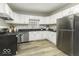 Bright kitchen featuring white cabinets, stainless steel appliances, and functional layout at 126 S 3Rd Ave, Beech Grove, IN 46107