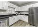 Well-lit kitchen boasting white cabinetry, stainless steel appliances, and a sleek countertop at 126 S 3Rd Ave, Beech Grove, IN 46107