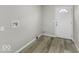 Mudroom with plank flooring and a door with a half-round glass window at 126 S 3Rd Ave, Beech Grove, IN 46107